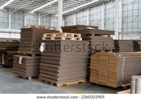 Paper packaging manufacturing. Pile of paper packaging in warehouse storage. Stacking of paper cardboard in warehouse