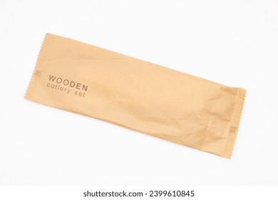 Paper Packaging of Wooden Cutlery in  Isolated, Eco Tableware, Disposable Cutlery, Recycle. Eco food packaging concept, zero waste paper, sustainability.