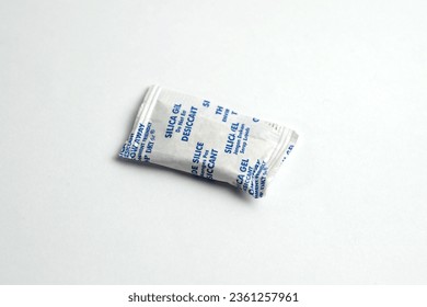 Paper packet of silica gel isolated on white, Silica gel has the property of being able to absorb moisture well. This makes silica gel often used to prevent rust formation on metal. - Shutterstock ID 2361257961