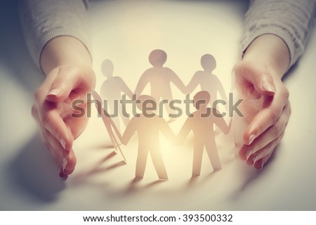 Paper people surrounded by hands in gesture of protection. Concept of insurance, social protection and support. 