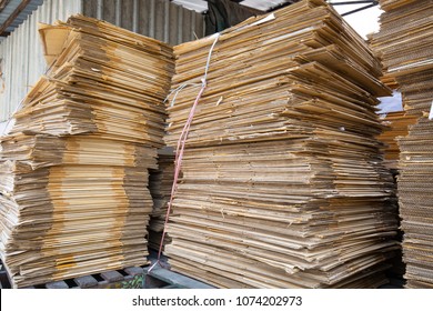 Paper pile and piece of cardboard at the recycle industry paper plant