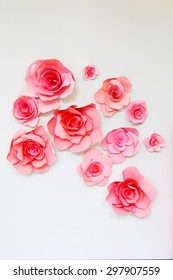 Paper Pink Decorative Flowers On A White Wall