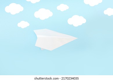 Paper Plane On A Blue Background With Clouds, Minimalistic Mockup