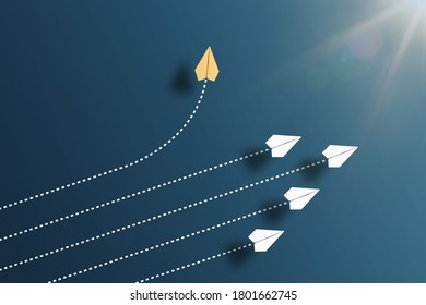 paper planes flying in formation in one direction on blue background and one paper glider going in different direction, breaking new ground and stepping out of the line concept