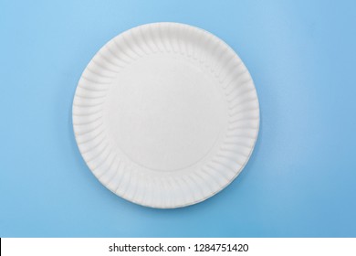 Paper plate isolated on blue background.