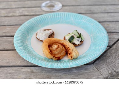 A Paper Plate With Canapés At A Potluck In The Summer