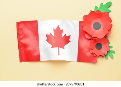 Paper Poppy Flowers With Flag Of Canada On Color Background. Remembrance Day