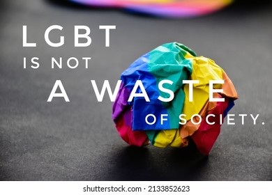 Paper recycle ball in rainbow colors which has texts 'LGBT is not a waste of society' , concept for lgbt celebrations in pride month, June, all over the world.