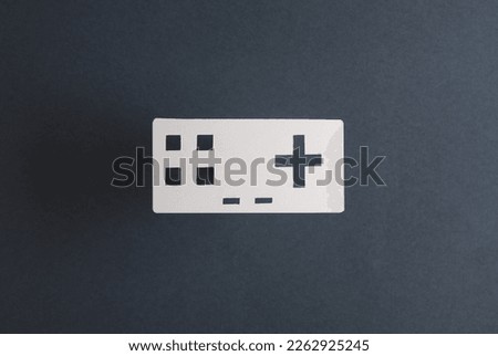 Paper retro gamepad icon on gray background
