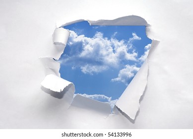 Paper Ripped To Reveal Blue Sky.