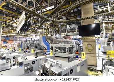 paper rolls and offset printing machines in a large print shop for production of newspapers and magazines - Shutterstock ID 1924349927