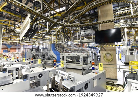 paper rolls and offset printing machines in a large print shop for production of newspapers and magazines