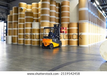 paper rolls and offset printing machines in a large print shop for production of newspapers and magazines