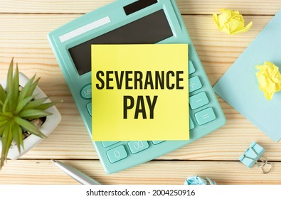 Paper with Severance Pay on the table, calculator and paper clips on wooden background.