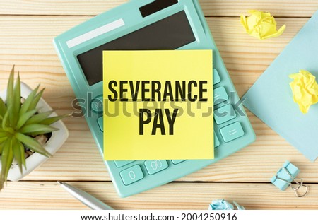 Paper with Severance Pay on the table, calculator and paper clips on wooden background.