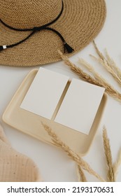 Paper Sheet Cards With Mockup Copy Space. Straw Hat, Muslin Blanket, Pampas Grass Stems, Neutral Beige Plate