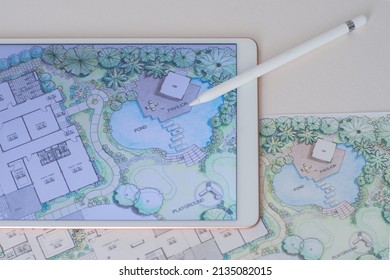 paper sheet of layout plan that shown design of house landscape or garden design drawing by hand with color marker pens and color pencil, shown by tablet computer, selective focus