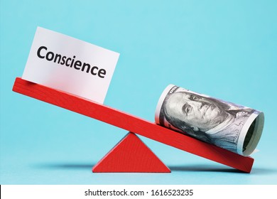 Paper Sheet And Money On A Swing. The Concept Of Conscience