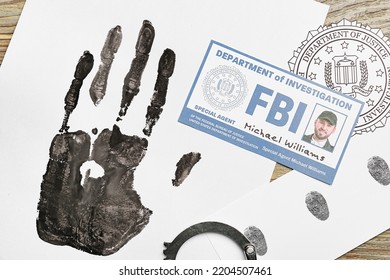 Paper Sheets With Different Prints And Document Of FBI Agent On Table