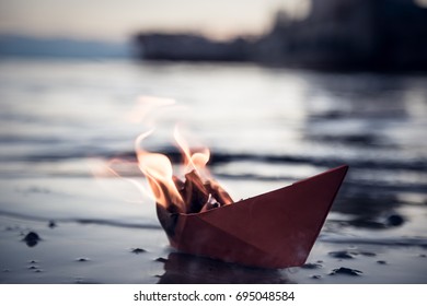 A paper ship burns on fire