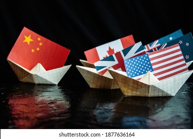 Paper Ship With Flags Of USA, Great Britain, Canada, Australia, Japan,EU And China Concept Of Conflict, Shipment Or Free Trade Agreement