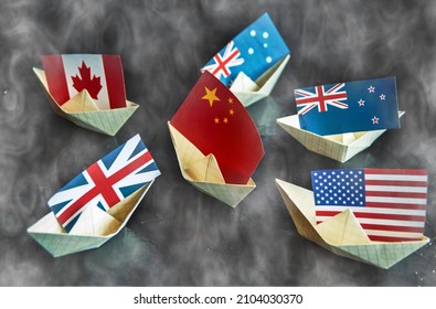 Paper Ship With Flags Of USA, Great Britain, Canada, Australia, Japan,EU And China Concept Of Conflict, Shipment Or Free Trade Agreement