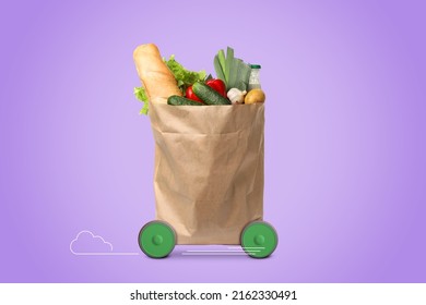 Paper shopping bag full of products on wheels against violet background. Order hurrying to client. Food delivery service - Shutterstock ID 2162330491
