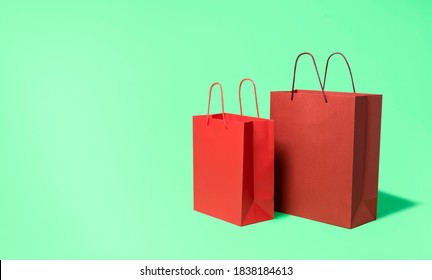 Paper shopping bags isolated on green mint seamless background. Shopping promotional flyer. Red paper bags for buying. Eco-friendly shopping packages. - Powered by Shutterstock