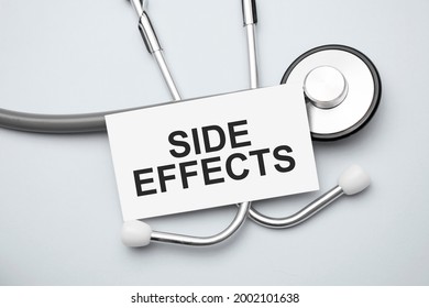 Paper with side effects on a table and grey stethoscope