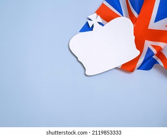 paper silhouette of the british royal crown on the background of the flag of the united kingdom of great britain and northern ireland - Shutterstock ID 2119853333