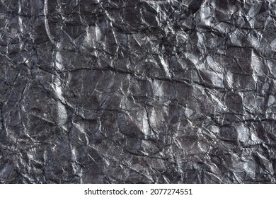 Paper silver wrinkled background. Abstract background made of crumpled paper for the design of texts, covers, web banners, logos. Mockup in solid color, textured pattern, gray background, copy space