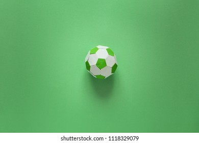 Paper Soccer Ball On Soccer Field Or Green Background. Origami. Paper Craft. Soccer Game Concept.