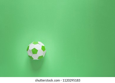 Paper Soccer Ball On Soccer Field Or Green Background. Origami. Paper Craft. Soccer Game Concept.