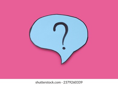 Paper speech bubble with question mark on pink background, top view