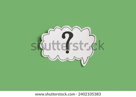 Paper speech bubble with question mark on green background