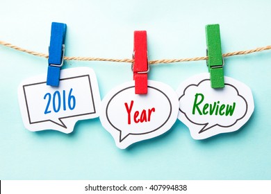 Paper speech bubbles with text 2016 Year Review hanging on the line.