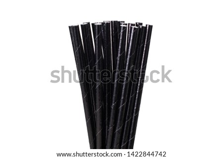 Paper straw of black colors on isolated background. Selective focus