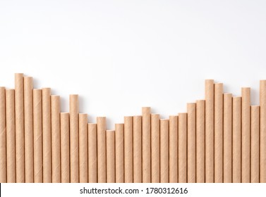 Paper straws lined up on a white background with copy space