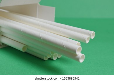 Paper straws on a green background