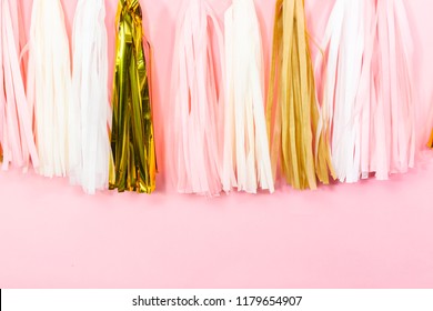 Paper Tassel Garland On A Pink Wall At The Kids Birthday Party.