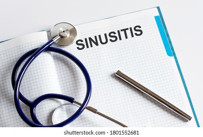 Paper with text SINUSITIS on a table with stethoscope