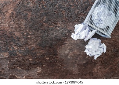 Paper Trash. Crumple Paper Falling To The Recycling Bin, Was Thrown To Metal Basket Bin, Overflowing Waste Paper In Office Garbage Bin Old Wooden Background Top View With Copy Space