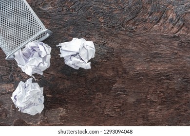 Paper Trash. Crumple Paper Falling To The Recycling Bin, Was Thrown To Metal Basket Bin, Overflowing Waste Paper In Office Garbage Bin Old Wooden Background Top View With Copy Space