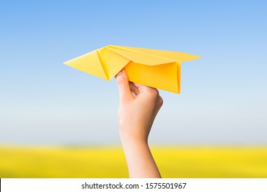 Paper Travel Sky Plane Child Flying Yellow Fun Human Leisure Kid Throw View Throwing Handmade Freedom Object Up Air Airline Joy Concept - Stock Image