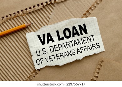 Paper with VA loan - U.S. Departament of Veterans Affairs text centered on torn paper. pointing to the text with a pencil