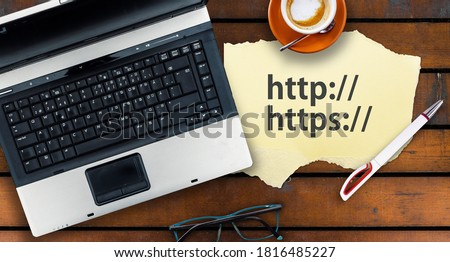 Paper width http and https and laptop on wooden table
