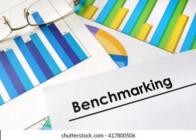 Paper with words Benchmarking and charts.
