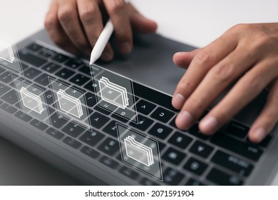 Paperless Workplace Concept Based On E-documents. On A Virtual Screen, A Businessman Works On A Laptop Computer Keyboard With Electronic Document Icons.