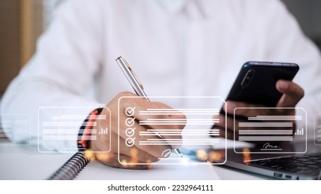 Paperless workplace ideas, e-signing, electronic signature, document management. A businessman signs an electronic document on a digital document on a virtual screen using a stylus pen. - Shutterstock ID 2232964111