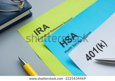 Papers about IRA, HSA and 401k plan on desk.